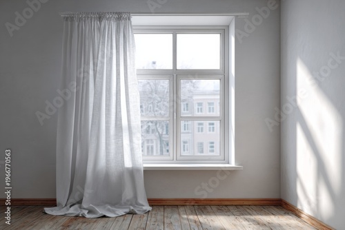 Light streams through a window with white curtains onto a wooden floor.