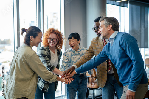 Quadro em tela Diverse business team stacking hands showing unity and collaboration