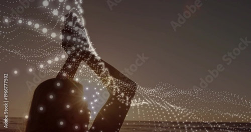 Silhouette woman raising hands, sun aligning at head, animating dotted wave showing tech data flow
