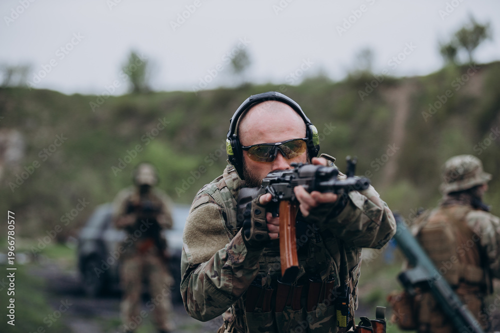 Fototapeta premium Ukrainian soldier covering a drone operator