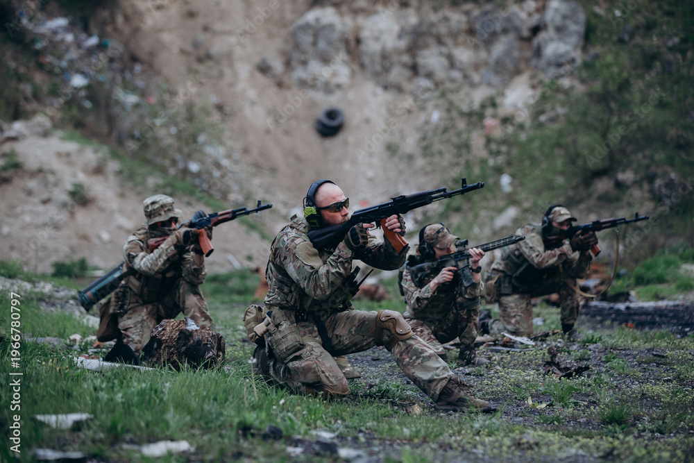 Fototapeta premium Four Ukrainian soldiers aiming their weapons during training