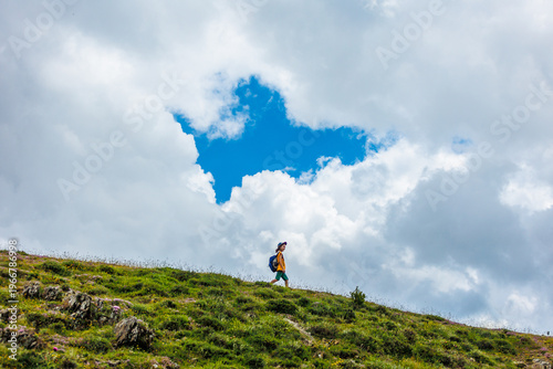 Traveling child. a tourist with a backpack walks along a mountain road. hiking and active healthy lifestyle.