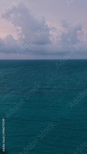 Aerial view beautiful oceanic sunset landscape, pink clouds, turquoise water