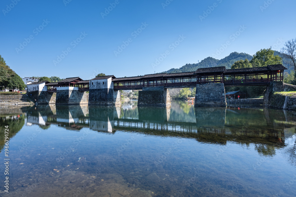 Fototapeta premium Traditional Chinese Covered Bridge Over Still River