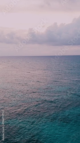 Aerial view beautiful oceanic sunset landscape, pink clouds, turquoise water
