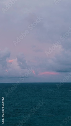 Aerial view beautiful oceanic sunset landscape, pink clouds, turquoise water