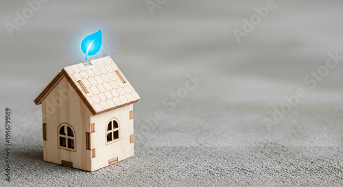 Eco friendly sustainable housing concept with glowing blue leaf icon on wooden house model and copy space for green real estate banner