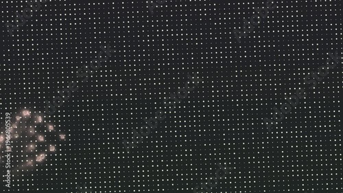 Abstract image of a dotted background with a cluster of glowing geometric shapes