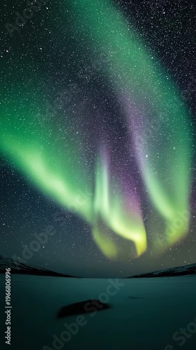 Spectacular Aurora Borealis Dance Over Icy Landscape at Night. cinematic vertical 9:16 footage, ultra HD, natural light, high detail, professional stock video
