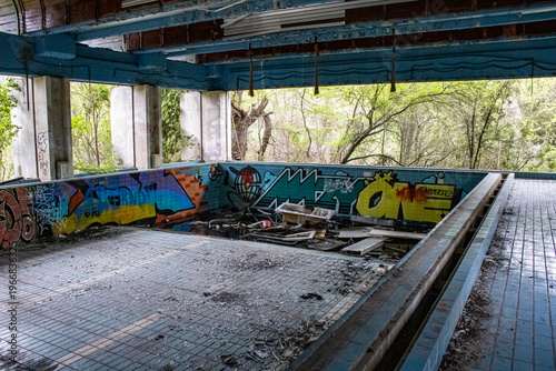 Abandoned industrial factory interior with empty swimming pool