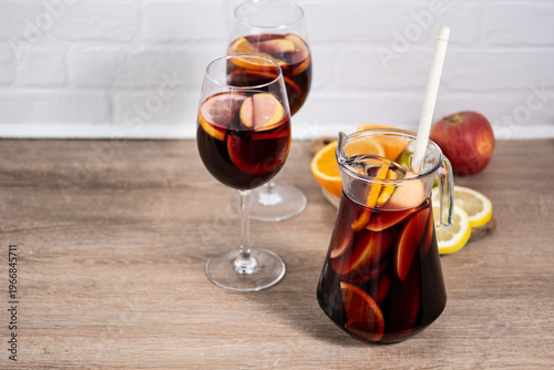 Sangria cocktail with fresh fruit on wooden table. Copy space