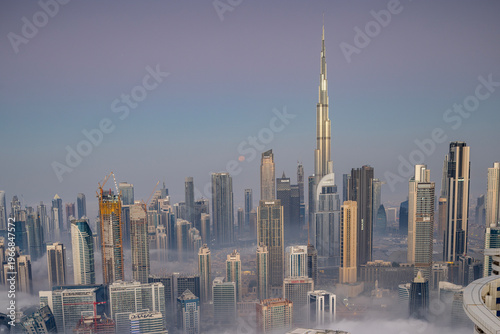 Photography sunrise of fog and clouds below the dubai skyline from a high vantage point