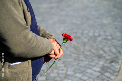 Portugal April 25th an elderly man holding a red carnation The Concept of Memory