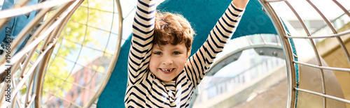 Quadro su tela Joyful child exploring autumn playground adventure with delight and wonder