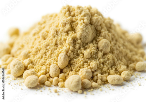 Macro photograph of a coarse pile of bright yellow powder or flour, possibly mustard powder or cornmeal, with small clumps and granular texture, isolated on a white background.