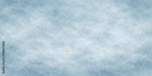 A beautiful summer day features a clear blue atmosphere where white cumulus clouds drift through the light air to create a textured nature background under the bright heavens