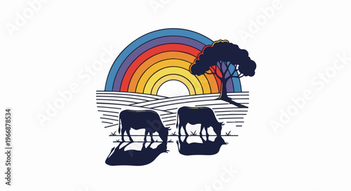 Silhouettes of cows graze by water under a rainbow and tree