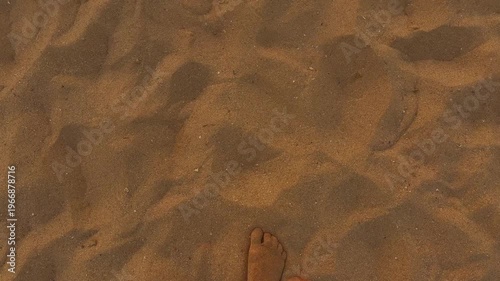 Strolling Along Sunset Beach. Relaxing Barefoot Journey During Sunset With Shifting Footprints