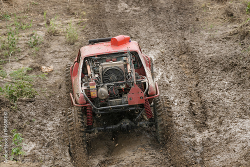 Red Pickup off road  4WD spin mud dirty track on mountain hill.     