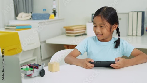 Young girl having fun working on a robot design