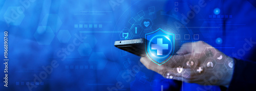Hand holding smartphone with medical shield on blue healthcare technology background