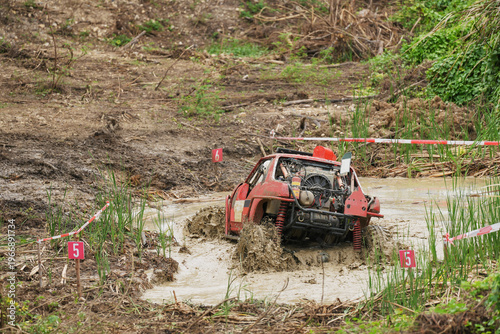 Red Pickup off road  4WD spin mud dirty track on mountain hill.     