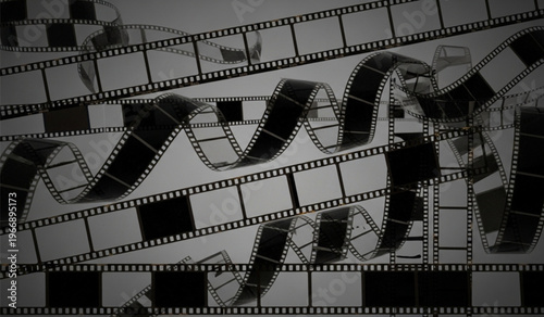 Chaotic entanglement of vintage 35mm film strips on gray background