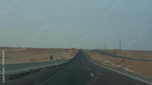 Calm Empty Highway Under Cloudy Sky. Open Barren Road Stretching Beneath Pale Overcast Sky