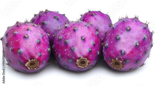 Group of vibrant pitaya fruits in shades of purple resting on a white background