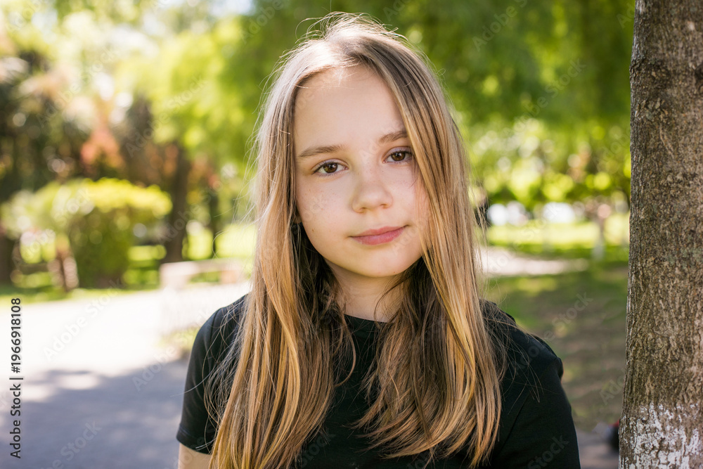 Obraz premium Beautiful child looking at camera outdoors. Beautiful girl portrait