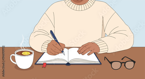A person wearing a cream sweater writes in an open notebook next to a warm tea