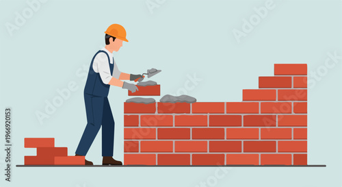 A construction worker wearing a hard hat lays bricks to build a sturdy wall
