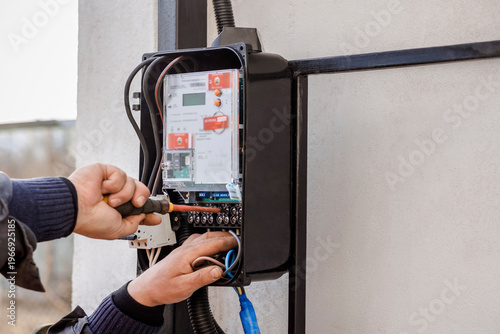 Electric Meter Box Installation Outside by Professional Worker  Electrician. Modern Smart Meter Install Service and Monitoring.