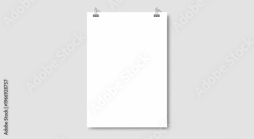 Blank white paper with metal clips against a gray background