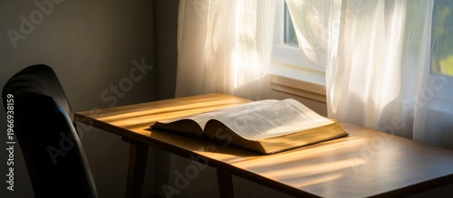 Open Bible on Wooden Desk by Window