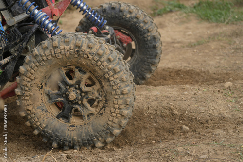  SUV Car racing offroad wheels on steppe terrain splashing with dirt offroad car in action. Dirty car drive high speed on mud gravel road. Provide the best experience off road travel concept big 4x4.