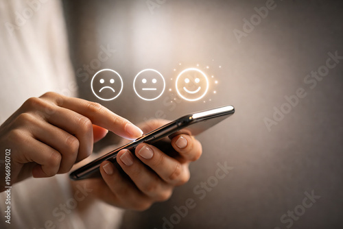 Female Hand Scrolling Smartphone with Smiley Feedback Icons
