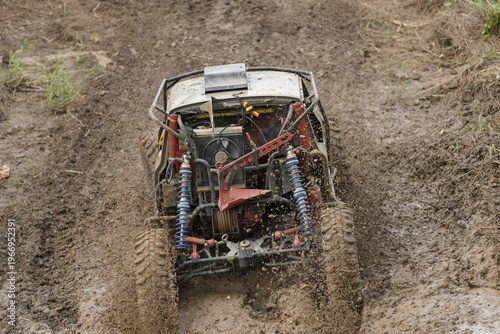 Red Pickup off road  4WD spin mud dirty track on mountain hill.     