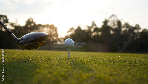 Foto Golf clubs and golf balls on a green lawn in a beautiful golf course with morning sunshine