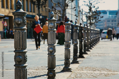 Decorative Cast Iron Bollards In A Row On A Busy City Street