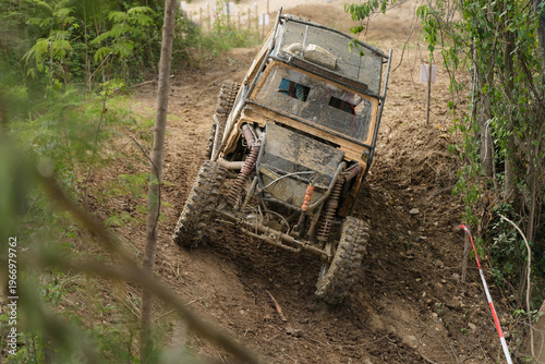 Red Pickup off road  4WD spin mud dirty track on mountain hill.     