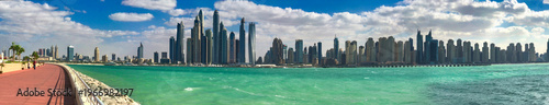 Wallpaper Mural Stunning Dubai Marina skyline towering above pristine beach with modern skyscrapers against clear horizon line Torontodigital.ca