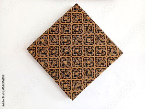 Classic Javanese batik fabric with traditional Sogan pattern on white background. Elegant ethnic textile from Indonesia for fashion and cultural design.