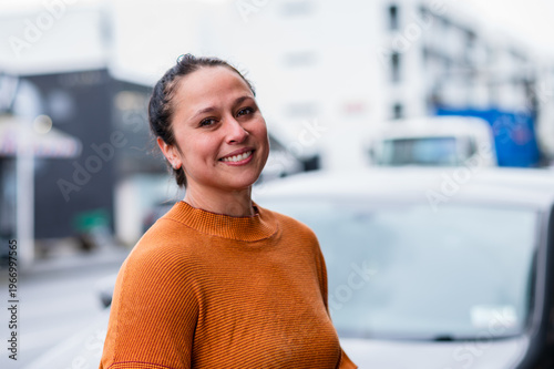 Portrait of an adult woman standing on the street sidewalk in Auckland