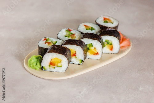 Obraz na plátne Sushi rolls on a plate with ginger and wasabi