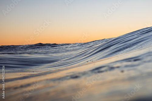 Photos Close-up of textured ripples forming as an ocean wave builds over a shallow reef