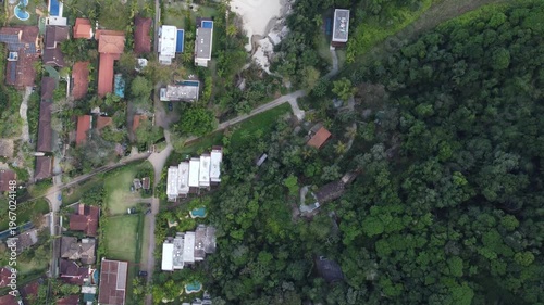 Aerial top down 4K view of Maresias beach coastline and luxury houses on a cloudy day