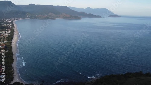 Aerial 4K wide view of Maresias beach coastline and mountains in Sao Sebastiao, Brazil