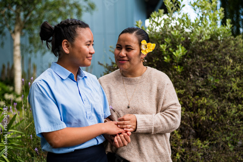 Maori mum walks with teenage daughter on the roadside