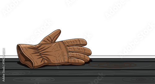 A single brown leather work glove lies horizontally on a dark wooden surface with visible grain.